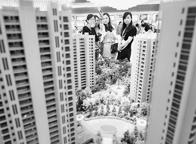 圖為近日，浙江杭州一家房產(chǎn)公司的兩位銷售人員一起向購房者介紹樓盤。新華社記者 王定昶攝