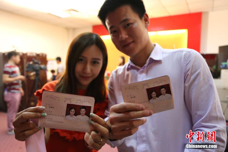 5月20日,河南鄭州,一對準新人領(lǐng)完結(jié)婚證后秀自拍。