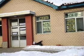 伊春市帶嶺區(qū)一排破舊的平房，房間窗戶上貼滿了“我告饒了”的字樣。