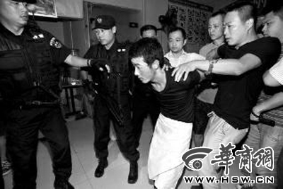 犯罪嫌疑人韓牙某圍著圍裙在廚房?jī)?nèi)拉面，被民警抓獲 本報(bào)記者 鄧小衛(wèi) 攝
