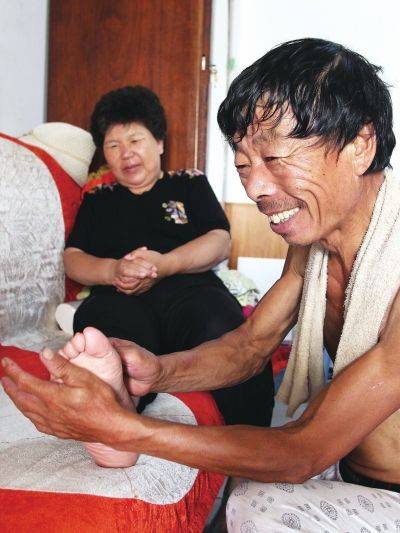 慈成富為老伴按摩。