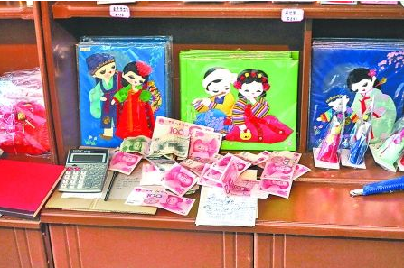 　　2012年6月21日，在朝鮮羅先特別市的一家商店里，柜臺(tái)上散落著一些人民幣。在朝鮮，人民幣比本國(guó)