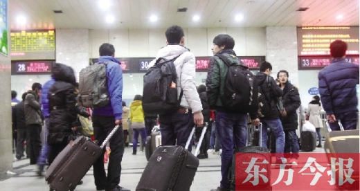 鄭州火車站東廣場售票大廳，幾名學生在售票窗口前躊躇