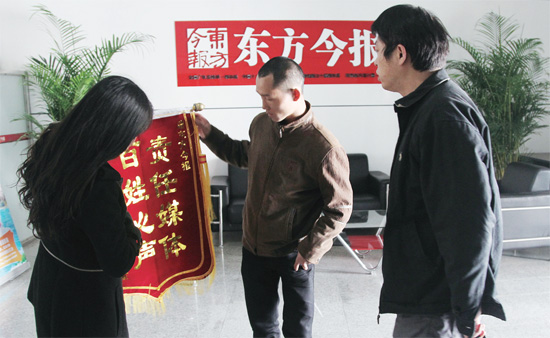 3月5日，三門峽讀者給本報送來錦旗，贊揚本報記者對其一家的幫助