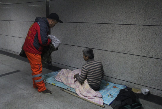 在鄭州一處地下通道，孫德坤挑了幾件衣服送給了流浪者