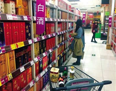 顧客在商場的高檔白酒貨架前駐足挑選。春節(jié)臨近，受“禁令”影響，以高檔白酒為代表的節(jié)日禮品市場面臨考驗(yàn)。記者 王遠(yuǎn)征 攝