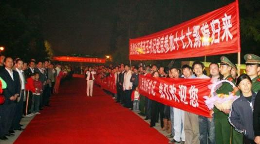 “夾道歡迎”中不少人打出橫幅，路上被鋪上了紅毯。
