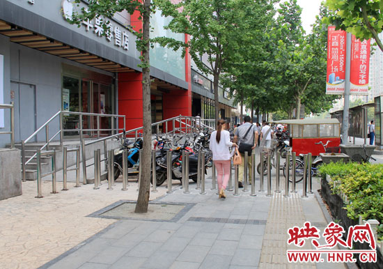 圖中道路左側(cè)的無(wú)障礙通道被鋼管隔離,右側(cè)的盲道也被侵占。