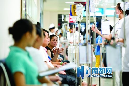 醫(yī)院走道坐滿了打吊針的員工。